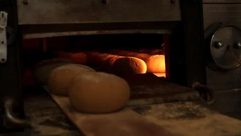 Freshly baked bread loaves inside an industrial oven Stock Photos