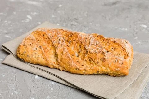 Freshly baked bread with napkin on rustic table top view. Healthy white bre.. Stock Photos