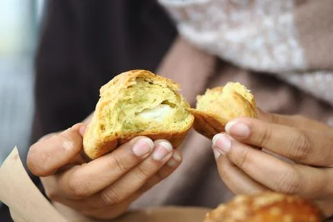 Freshly baked bread is pulled apart by hands Stock Photos