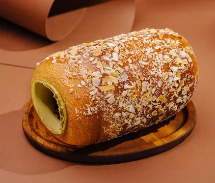 Freshly baked bread roll with nuts placed on wooden board Stock Photos