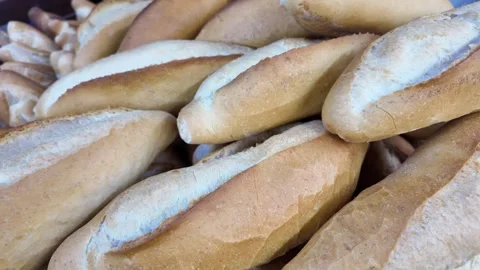 Freshly baked bread rolls arranged in bakery creating inviting display for .. Stock Footage 332268932
