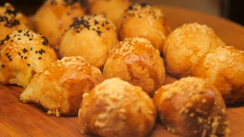Freshly baked bread rolls on display at a bakery Stock Footage 339998437