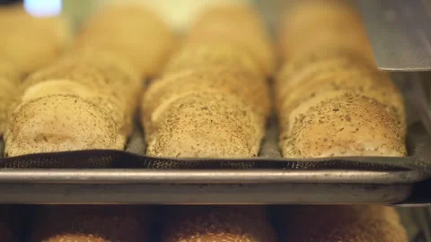 Freshly baked bread rolls with herbs on baking trays in a commercial bakery.. Stock Footage 333031850