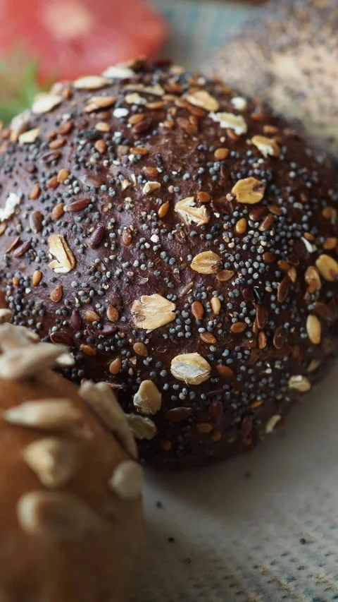 Freshly baked bread rolls with seeds and grains Stock Footage 339755592