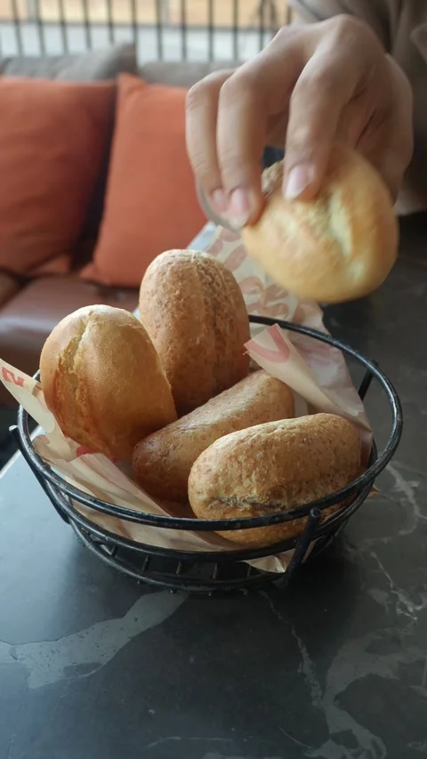 Freshly baked bread rolls served in a basket Stock Footage 336881390