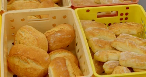 Freshly baked bread rolls in stacked plastic crates inside bakery production Stock Footage 344583550