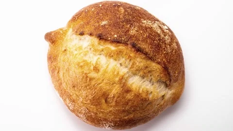 Freshly baked bread rotates on a white background, top view, stop motion, 3D. Stock Footage 148205325