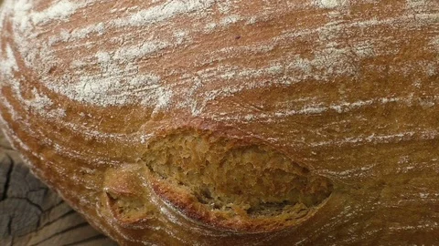 Freshly baked bread in rustic setting on wooden background Stock Footage 78749823
