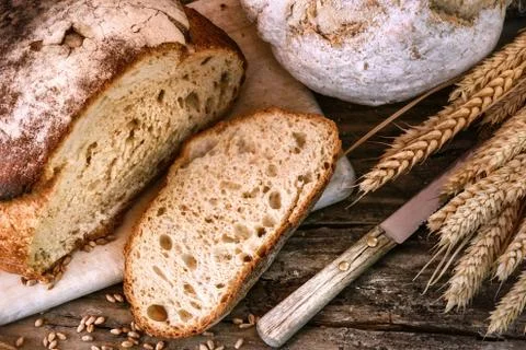 Freshly baked bread in rustic setting Stock Photos