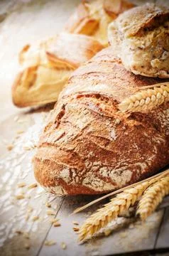 Freshly baked bread in rustic setting Stock Photos