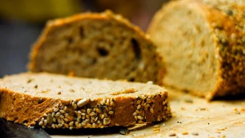Freshly baked bread with seeds. In the background is a romantic entourage Stock Photos
