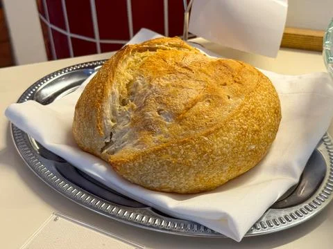 Freshly baked bread on silver tray. Warmth, tradition and simplicity of homem 写真素材