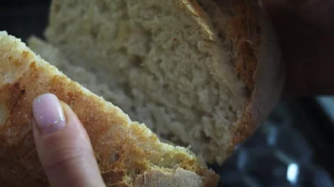 Freshly baked bread slice held in a hand Stock Footage 324031233