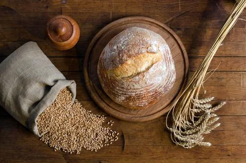 Freshly baked bread, spikelets and grain of wheat Stock Photos