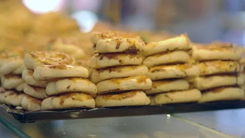 Freshly baked bread is stacked in a shop Stock Footage 338041996