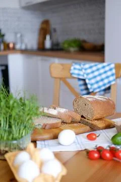 Freshly baked bread on the table cut into slices for sandwiches for breakfast or Stock Photos