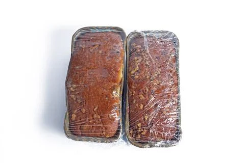 Freshly baked bread wrapped in plastic food packaging on a white background Stock Photos