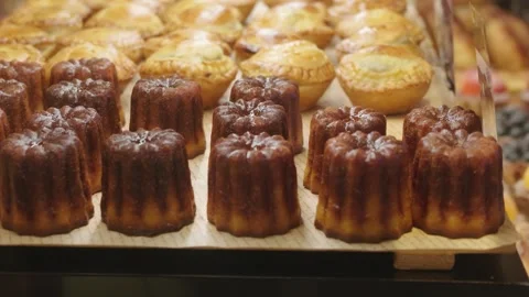 Freshly Baked Canele and Assorted Pastries Displayed in Bakery Vídeo Stock 346469657