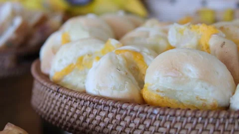 Freshly baked cheesy crescent bread and braided challah on bakery counter Stock Footage 310157981