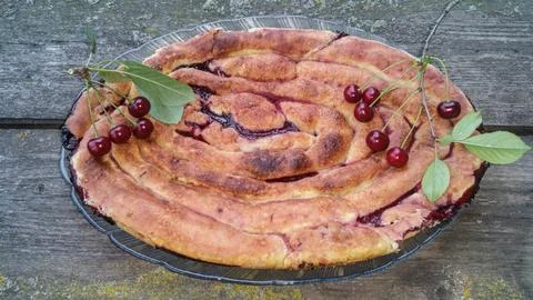 Freshly baked cherry pie with two cherry branches with berries Stock Photos