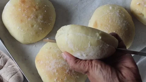 Freshly baked ciabatta bread being sliced to reveal a soft and airy crumb s.. Stock Footage 342633185