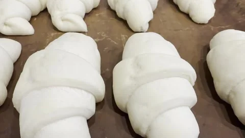 Freshly baked croissants on a baking sheet before baking. Stock Footage 339764299