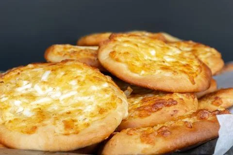 Freshly baked flatbreads with eggs on a large tray Stock Photos
