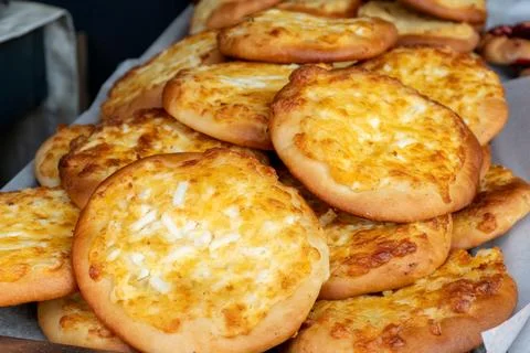 Freshly baked flatbreads with eggs on a large tray Stock Photos