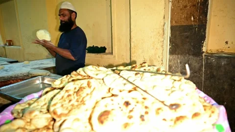 Freshly baked flatbreads stack neatly on wooden table Stock Footage 312724601