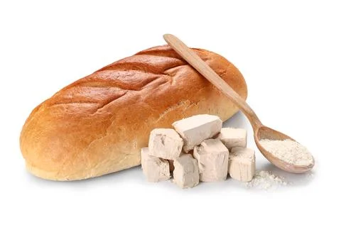 Freshly baked loaf of bread with active dry yeast and flour in wooden spoon f Stock Photos