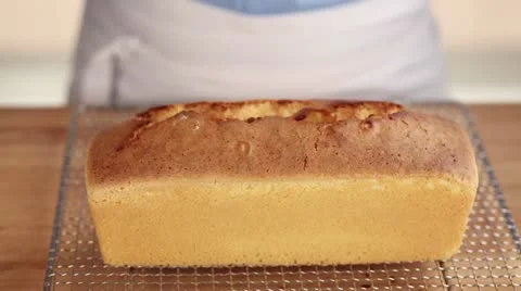 A freshly baked loaf cake on a wire rack Stock Footage 24657173