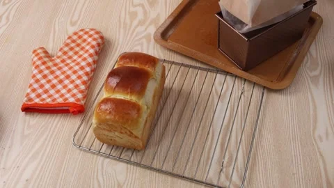 Freshly Baked Loaf of Toast Bread Cooling on Wire Rack Stock Footage 342120314