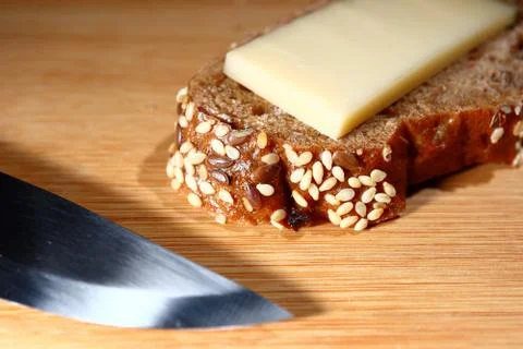 Freshly baked multi-grain bread with cheese on wooden background 스톡 사진