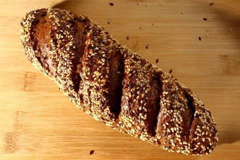 Freshly baked multigrain bread on rustic background, top view Stock Photos