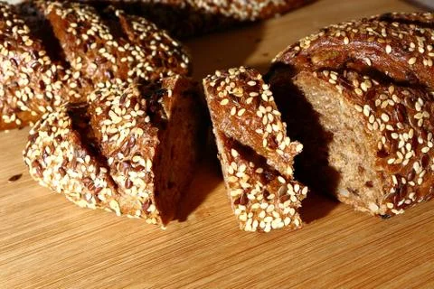 Freshly baked multigrain bread on rustic background, top view Stock Photos