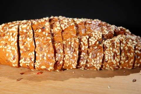 Freshly baked multigrain bread on rustic background, top view Stock Photos