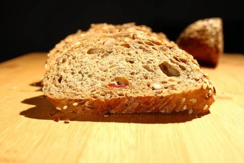 Freshly baked multigrain bread on rustic background, top view Stock Photos