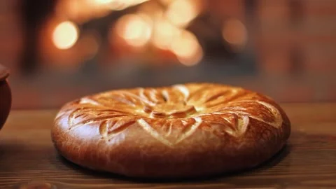 Freshly baked pie, bread against the fire. Video stock 264391696