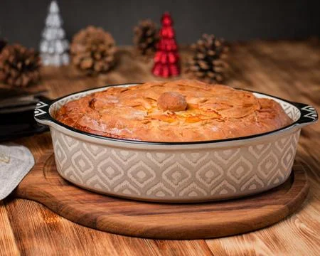 Freshly baked pie with duck meat, potatoes and onions. Stock Photos