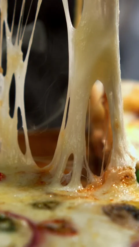 Freshly baked pizza slice with melted stretchy mozzarella cheese being pull.. Stock Footage 337536791