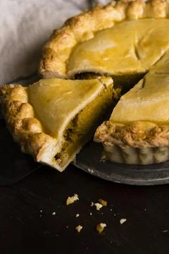 Freshly baked pumpkin pie with a slice cut out Stock Photos