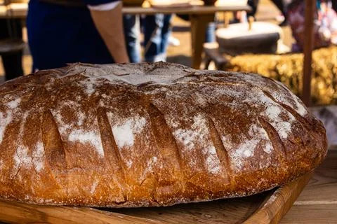 Freshly baked rustic brown bread closeup traditional pastries on wooden Stock Photos