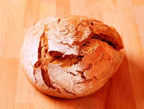 Freshly baked rustic sourdough bread on wood Stock Photos