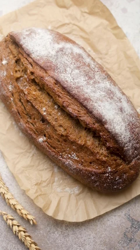 Freshly baked rye bread loaf dusted with flour Stock Footage 334922009