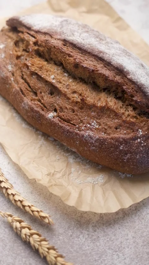 Freshly baked rye bread loaf dusted with flour Stock Footage 335686649