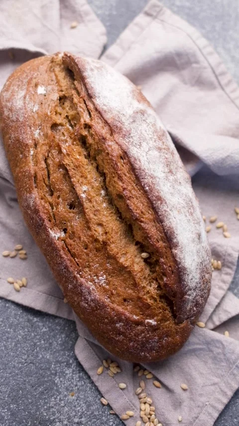 Freshly baked rye bread loaf rotating Stock Footage 336098966