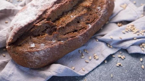 Freshly baked rye bread loaf rotating Stock Footage 336258094