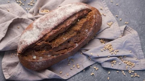 Freshly baked rye bread loaf rotating Stock Footage 336619782