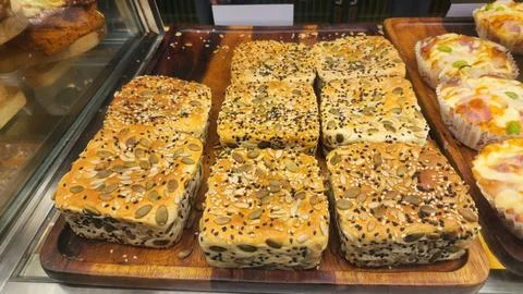 Freshly Baked Seeded Bread Rolls with Pumpkin and Sesame Seeds on Wooden Tray Stock Photos