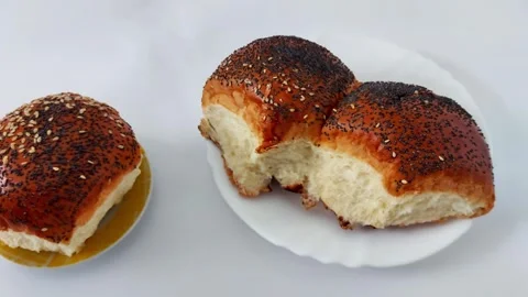 Freshly Baked Seeded Rolls Torn Open to Reveal Soft Interior Video stock 320859235